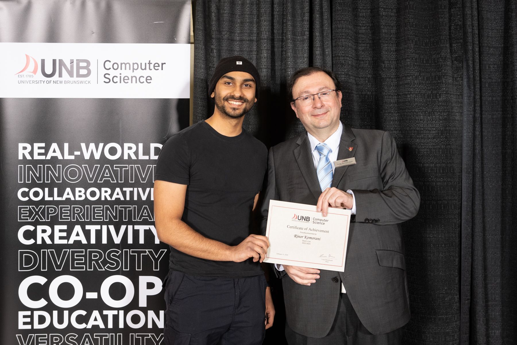 Rinor receiving Dean's List certificate at UNB Computer Science