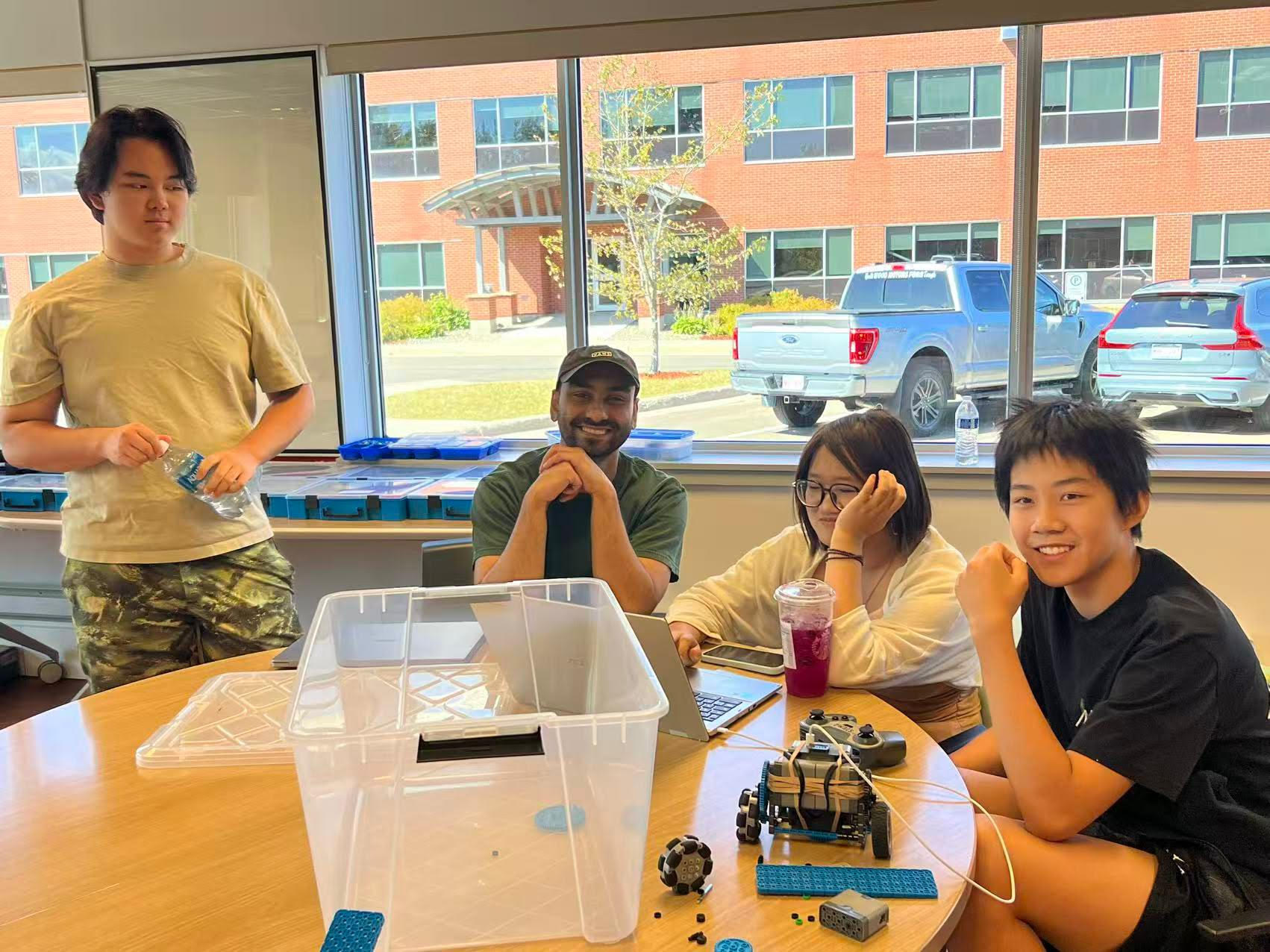 Rinor with students building a BBC Micro:bit robot at STEMBlock